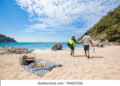 Happy Couple Picnic On The Beach.