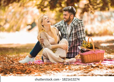 Happy couple picnic in the park during autumn fall season - Powered by Shutterstock