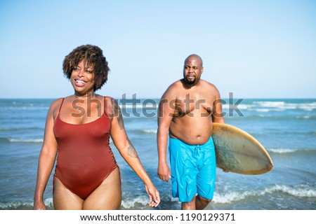 Happy couple playing in the sea
