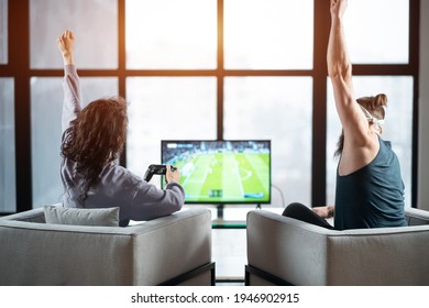 happy couple playing video game with controller on play station at home