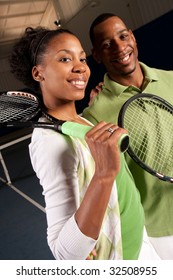 A Happy Couple Posing On A Tennis Court