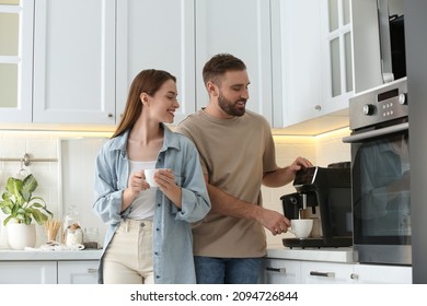 Happy couple preparing fresh aromatic coffee with modern machine in kitchen - Powered by Shutterstock