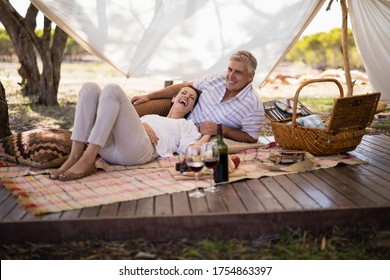 Happy couple relaxing in cottage during safari vacation - Powered by Shutterstock