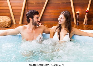 Happy Couple Relaxing In A Hot Tub