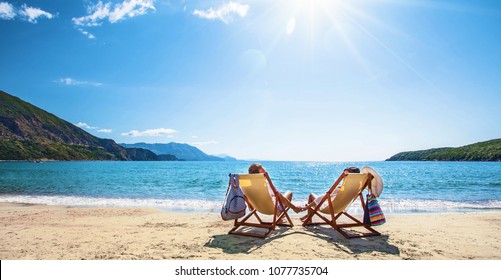 Happy couple relaxing on the beach. Summer vacation