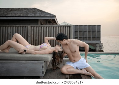 Happy couple relaxing at the swimming pool. - Powered by Shutterstock