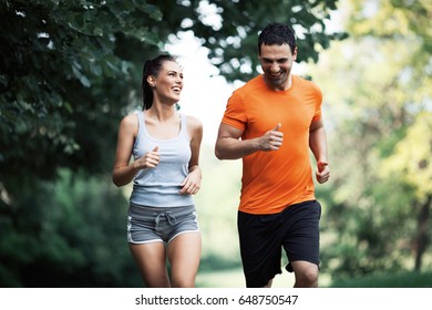 Happy couple running and jogging together - Powered by Shutterstock