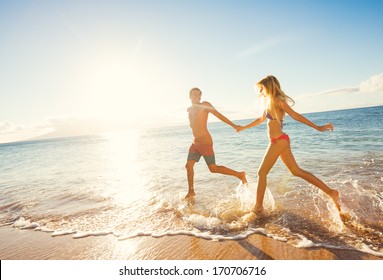 Happy Couple Running On Tropical Beach At Sunset, Vacation 