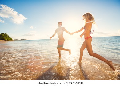 Happy Couple Running on Tropical Beach at Sunset, Vacation 