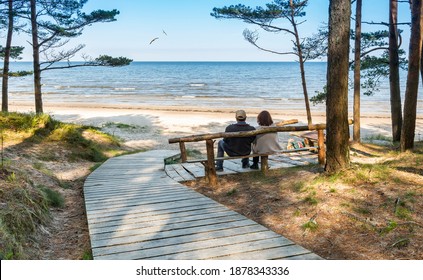 Happy couple of seniors are resting near a sandy beach of the Baltic Sea - Powered by Shutterstock