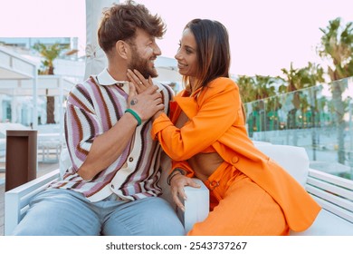 Happy couple sharing intimate moments at a beach resort, enjoying each other's company in a romantic setting. - Powered by Shutterstock