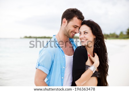 Happy couple sharing a tender moment at the beach