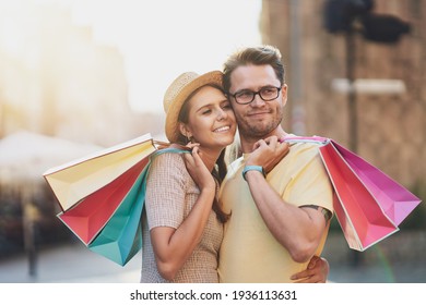 Happy Couple With Shopping Bags In The City