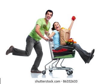 Happy couple with a shopping cart. Isolated over white background. - Powered by Shutterstock