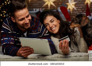 Happy Couple Shopping Online For Christmas At Home