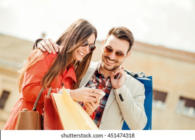 Happy Couple Shopping Together In The City.