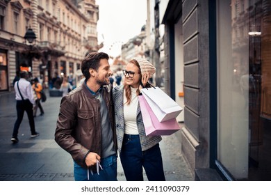 Happy Couple Shopping and Walking in the City - Powered by Shutterstock