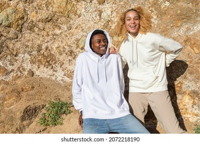 Happy couple in simple hoodies for winter outdoor shoot