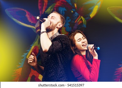 Happy Couple Singing In Karaoke Night Club