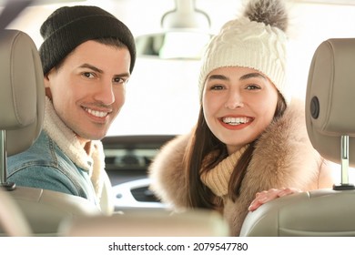 Happy Couple Sitting In Car On Winter Day