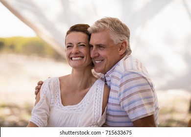 Happy couple sitting in cottage during safari vacation - Powered by Shutterstock