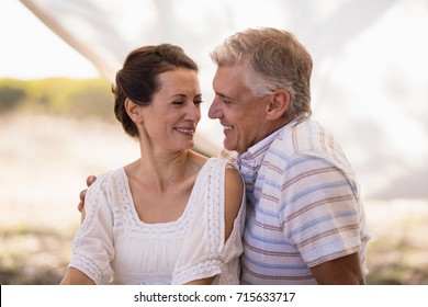 Happy couple sitting in cottage during safari vacation - Powered by Shutterstock