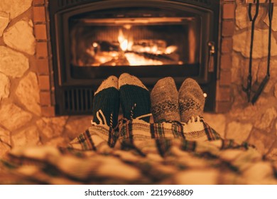 Happy couple sitting at home by fireplace, warm and cozy relaxing together. Cold winter in Europe concept. Wood stove using during energy crisis and high prices on gas. - Powered by Shutterstock