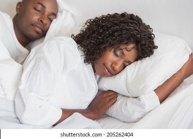 Happy couple sleeping together in bed at home in the bedroom