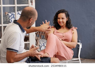 Happy couple smiling and flirting on patio - Powered by Shutterstock