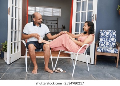 Happy couple smiling and flirting on patio - Powered by Shutterstock