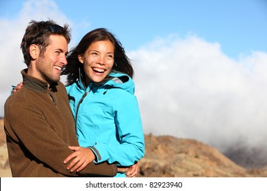 Happy Couple Smiling Outdoors On Hiking Trip. Young Mixed Asian Caucasian Couple Enjoying Nature.