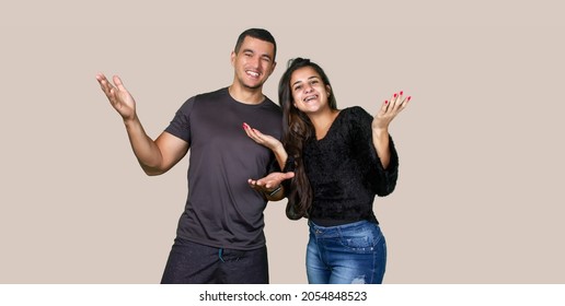 A Happy Couple In A Studio Shot With Solid Color Background.