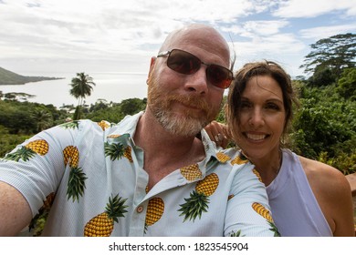 Happy Couple Takes Selfie In Front Of View On Moorea Island In T