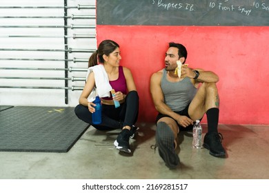 Happy Couple Taking A Break From Their Workout At The Gym. Young Woman And Man Eating A Snack After Exercising 