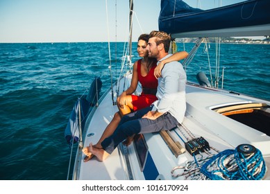 Happy Couple Taking A Romantic Cruise On The Sail Boat