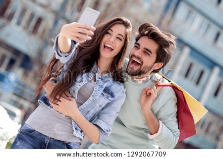 Similar – couple taking selfie in the street