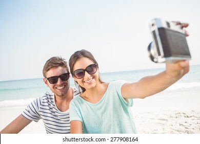 Happy Couple Taking Selfie At The Beach