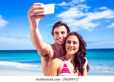 Happy Couple Taking Selfie At The Beach