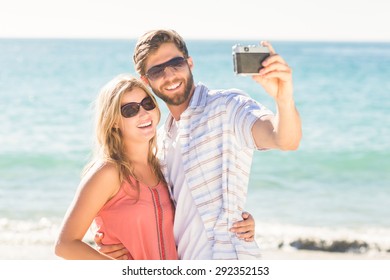 Happy Couple Taking Selfie At The Beach