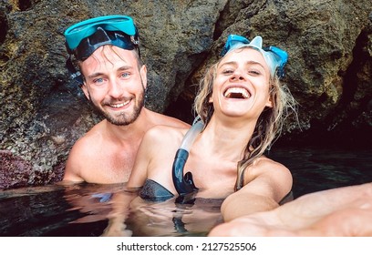 Happy Couple Taking Selfie Before Entering Water Cave With Waterproof Camera - Young People Snorkeling In Exotic Scenarios - Youth Life Style And Travel Concept Around The World - Warm Natural Filter