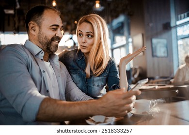 Happy couple taking selfie in a modern cafe - Powered by Shutterstock