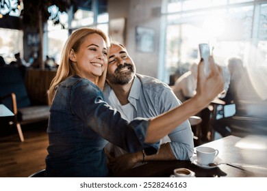 Happy couple taking selfie with smartphone in a cafe - Powered by Shutterstock