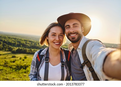 Happy couple taking selfie while hiking together - Powered by Shutterstock