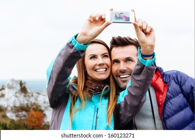 Happy Couple Taking Snapshot Of Themselves