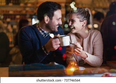 Happy couple talking at bar and having date