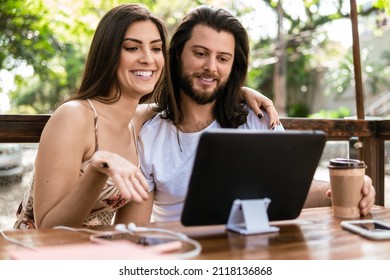 Happy Couple Talking On Video Call With Tablet In Table Outside