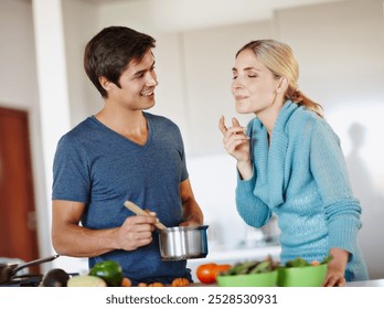 Happy, couple and taste food in kitchen of partners cooking, meal prep and vegetables ingredients for vegan. Smile, man and woman with culinary skills for breakfast salad, nutrition diet and house - Powered by Shutterstock