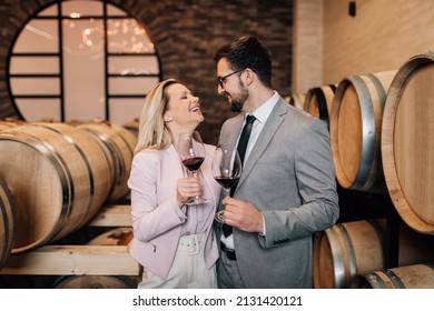 Happy Couple Tasting Red Wine In Old Fashioned Winery. 