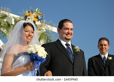 Happy Couple And Their Best Man On Their Wedding Day