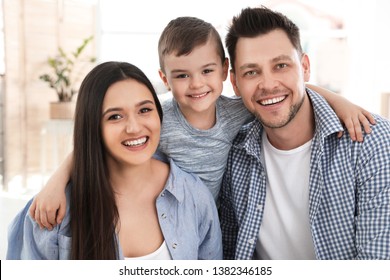 Happy couple and their son at home. Family time - Shutterstock ID 1382346185